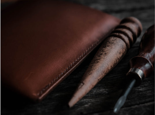 A leather bag filled with food and a flask of hot tea
